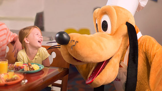 Mother and daughter with Pluto at Chef Mickey's